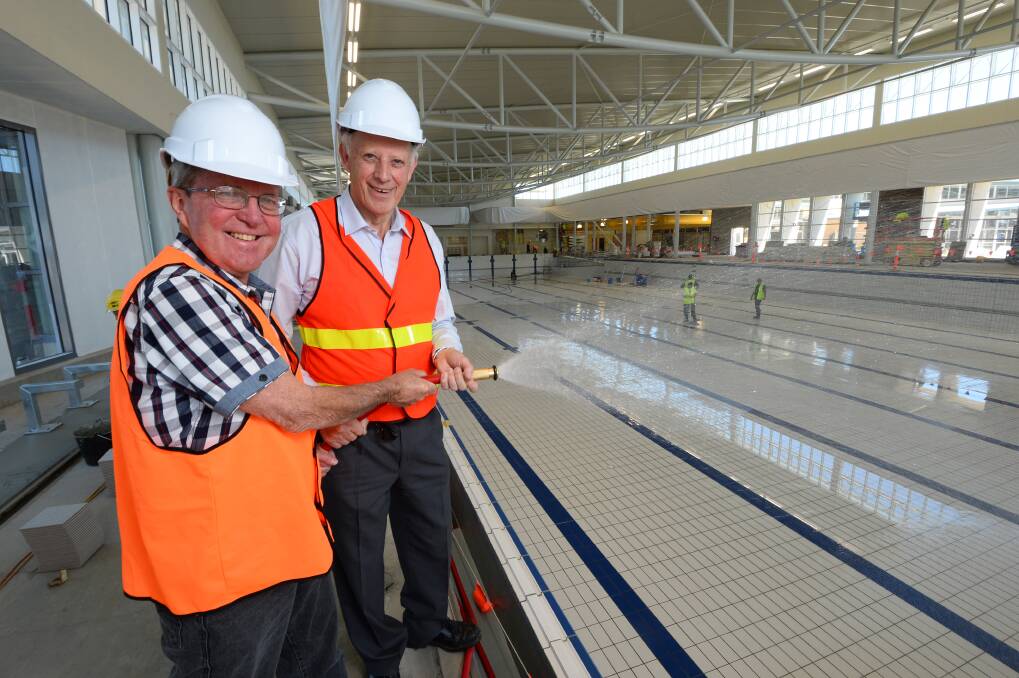 Turn it on: Councillor Peter Innes and Ballarat mayor John Philips start the process of filling the Ballarat Aquatic and Lifestyle Centre’s 50-metre swimming pool on Friday. The filling process is expected to take three days. PICTURES: ADAM TRAFFORD