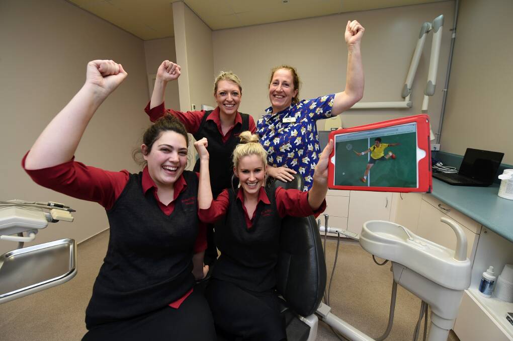 Coaches: Bakery Dental Group staff Alyshia Raats, Tiarne Harrison, Jacinta Curtis and Kylie Blake cheer on fellow workmate Dr Jeffrey Tho as he competes In the Commonwealth Games. PICTURE: LACHLAN BENCE