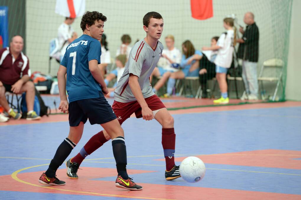 ON THE COURT: Victoria Country’s Lucas Hodgetts and Queensland Country West’s Christopher Wall in action at the Ballarat Futsal Centre on Monday night. PICTURE: KATE HEALY