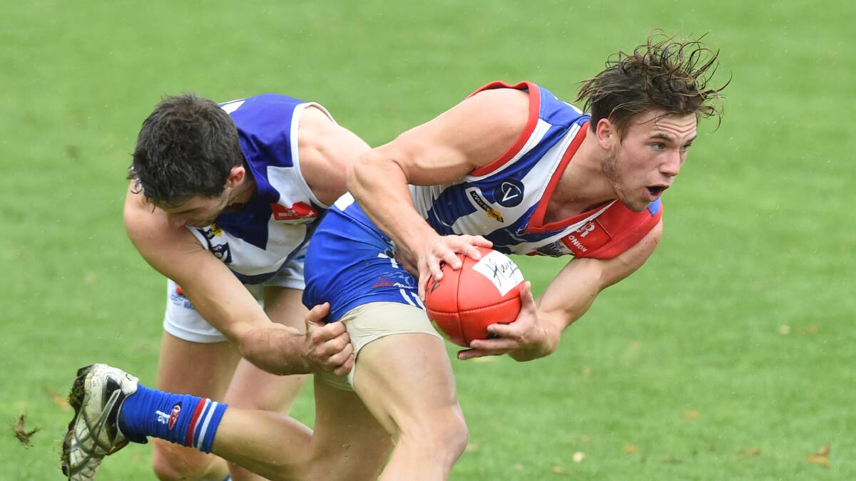 Caught: East Point’s Jack Romeril tries to escape a Sunbury tackle. PIcture: Lachlan Bence
