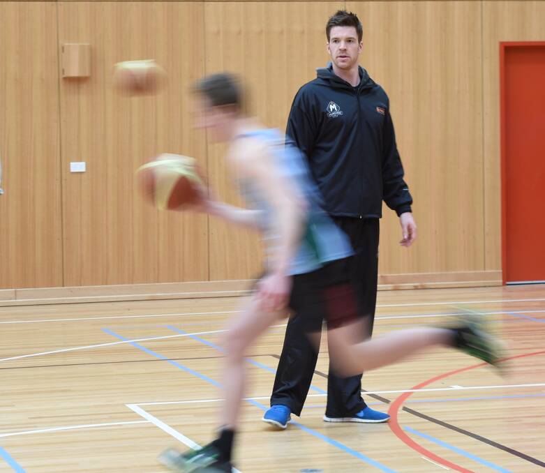 Old home: Melbourne United player Lucas Walker trains Ballarat High School students. PICTURE: LACHLAN BENCE