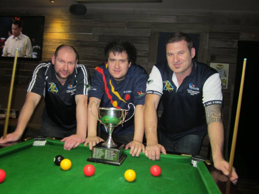 Champion: Jake McCartney with the Victorian Eight-Ball Championship trophy, flanked by fellow Ballarat players and state semi-finalists Jamie Stevens, left, and Mark Curwood.