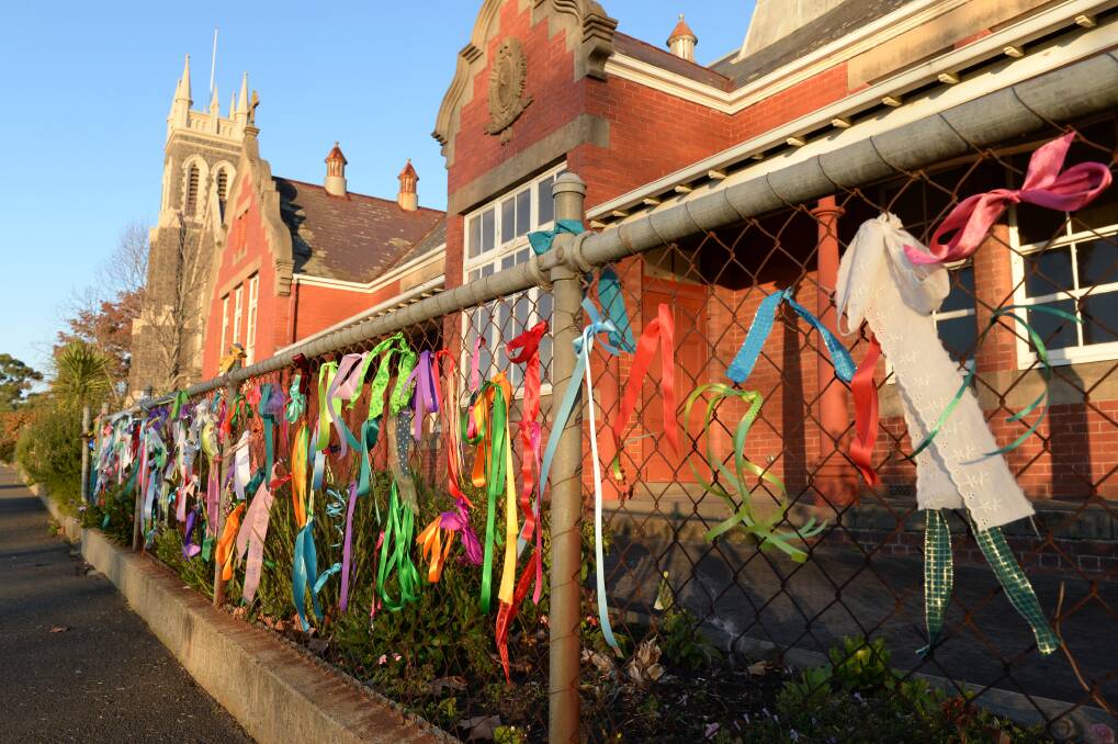 Not alone: Ribbons adorn the fence of the former St Alipius Christian Brothers’ boys’ school in support of abuse victims. PICTURE: KATE HEALY