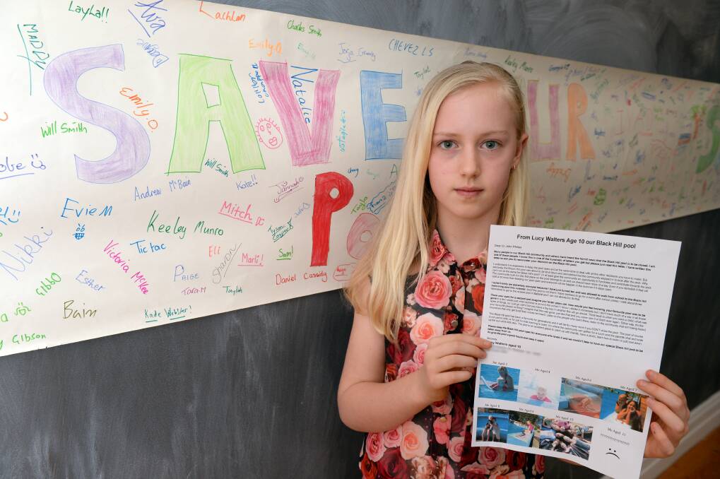 Plea: Lucy Walters, 10, with her letter to Ballarat City Council, requesting that the Black Hill pool remains open. PICTURE: KATE HEALY