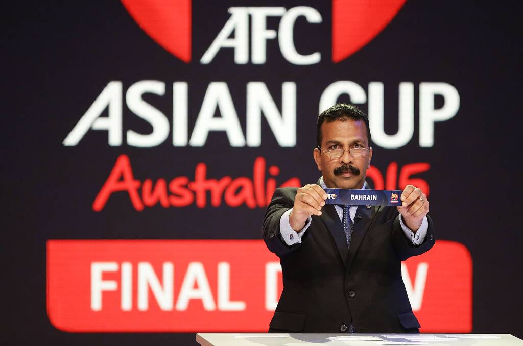 AFC General Secretary Dato' Alex Soosay holds up the name of Bahrain during the final draw for the 2015 AFC Asian Cup draw in Sydney in March.