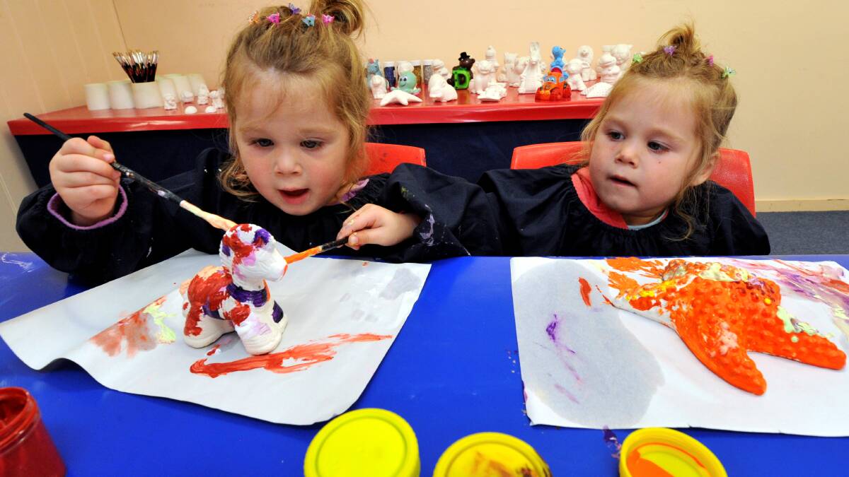 Painting fun: Twins Ella and Jade Willison, 2, having some fun painting their plaster pieces. PICTURE: JEREMY BANNISTER
