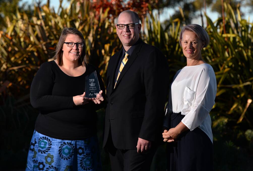 Success: Administrative Professional of the Year Catherine Stoney with her award, United Way chief executive Geoff Sharp and Administrative Professionals Breakfast keynote speaker Lisa Hayden. PICTURE: ADAM TRAFFORD