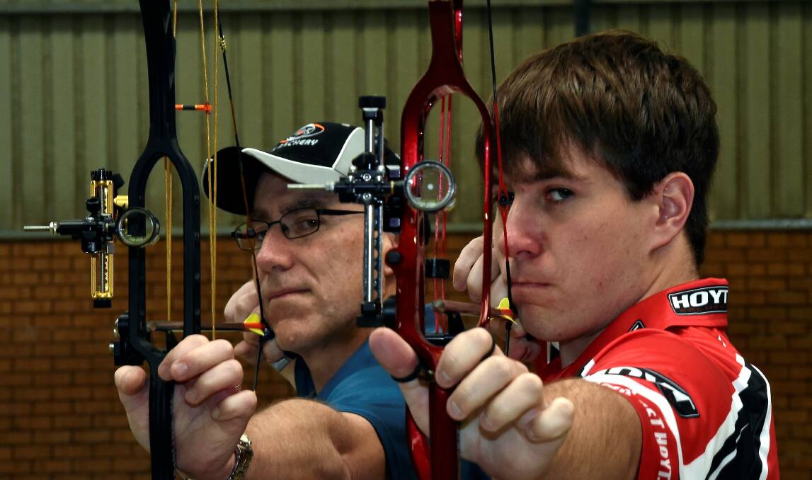 Ready to fire: Father and son national archery champions Geoff and Mitchell Rogers.