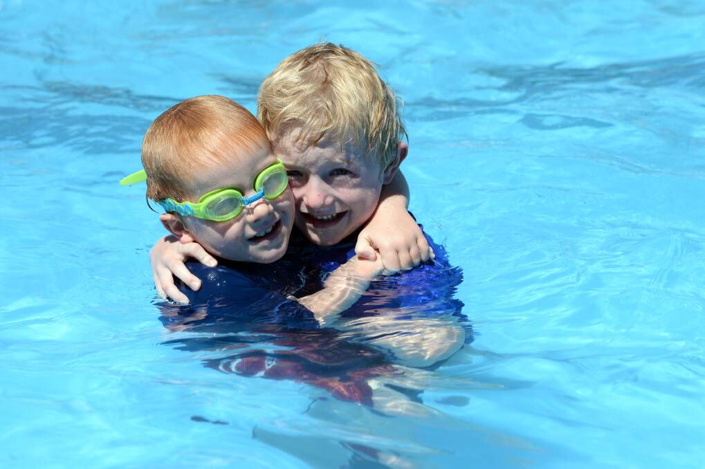 Cooling off: Todd, 4, and Rex Brennan, 6, of Ballarat, having some summer fun at the Eureka pool. PICTURE: KATE HEALY