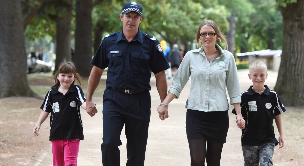 Ready to walk: Getting ready to take part in the annual Walk for the Kids around Lake Wendouree tomorrow are, from left, Keisha Darroch, 7, Senior Constable Craig Walker, Ashleigh Ransom, and Isaac Darroch, 9. PICTURE: LACHLAN BENCE