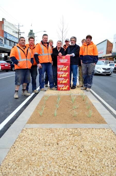 Well done: Armstrong Street workers Glenn Reid, Mitchell Holland, John Degrandy, Barry O’keefe, Karl Masterson, Dylan Scott and Darcy Steer with Campagna’s Darrian Todd and Peter Voterakis.