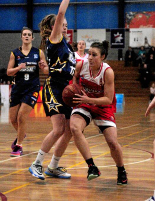 Under pressure: Rush captain Abbey Wehrung and Tornado Lauren Mansfield in action. 
PICTURE: NEIL RICHARDSON