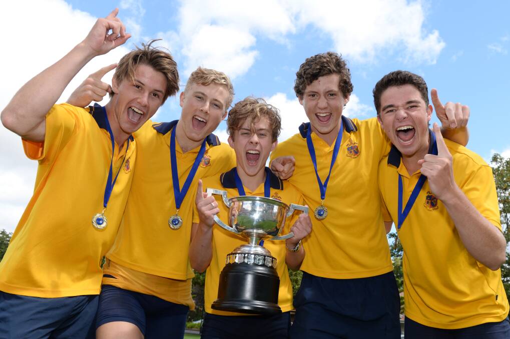 ‘Oarsome’: Ballarat Grammar’s Nic Williams (stroke, captain), Ted Hunt (three), Thom Leadbetter (cox), Lloyd Meek (two) and Ben Trotter (bow) with their championship trophy. PICTURE: KATE HEALY