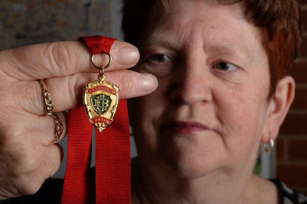 Surprise: Op shop manager Anne Hardy with the mystery Henderson Medal. PICTURE: KATE HEALY