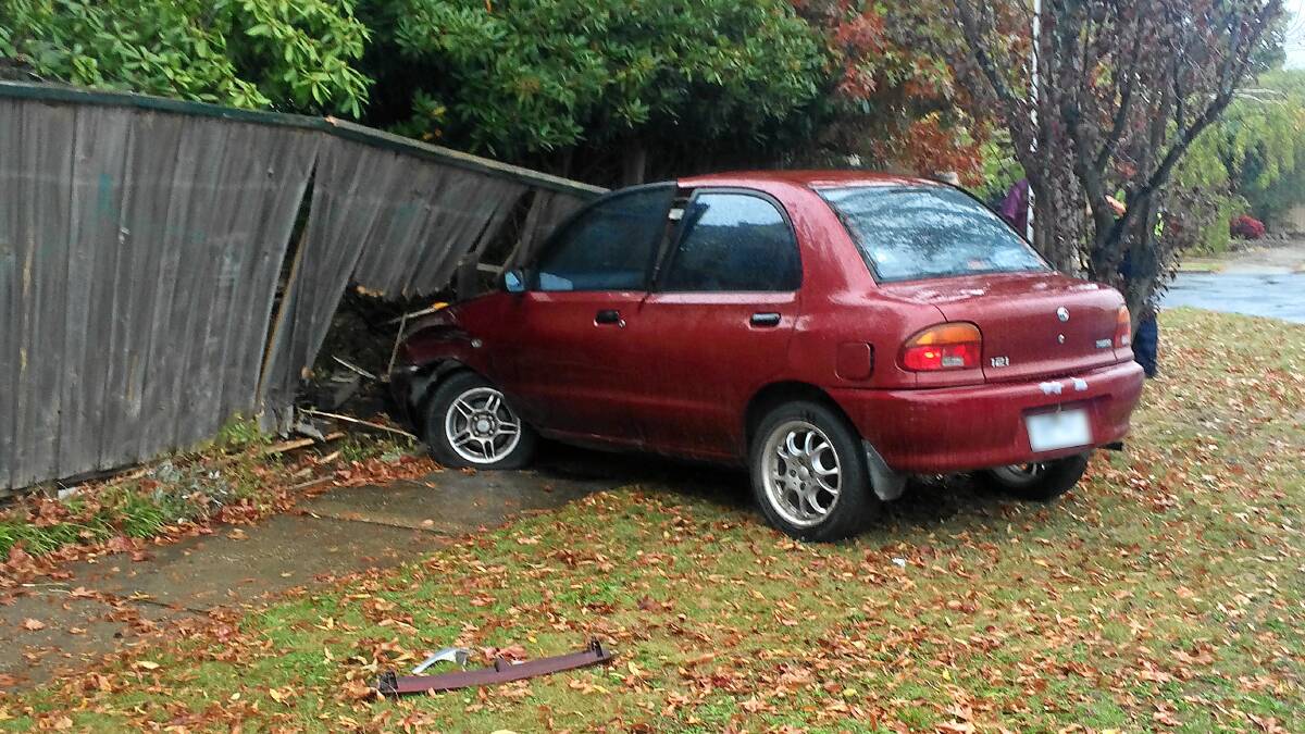 Damage: A woman crashed her car into the fence of a Grevillea Road, Wendouree, house on Saturday.
PICTURE: ALEX HAMER
