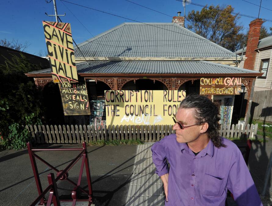 Unhappy: Patrick van Raaphorst with the protest signs outside his Armstrong Street South home. PICTURE: LACHLAN BENCE