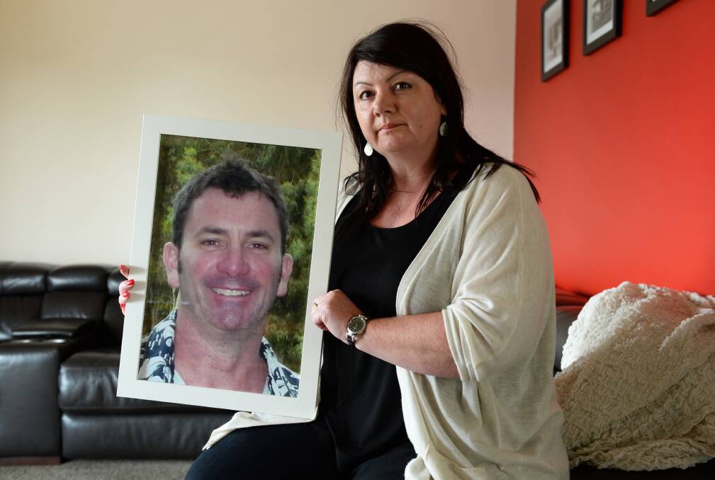 Bereft: Felicity Harte with a picture of her brother Andrew Lund, who battled post-traumatic stress. PICTURE: ADAM TRAFFORD
