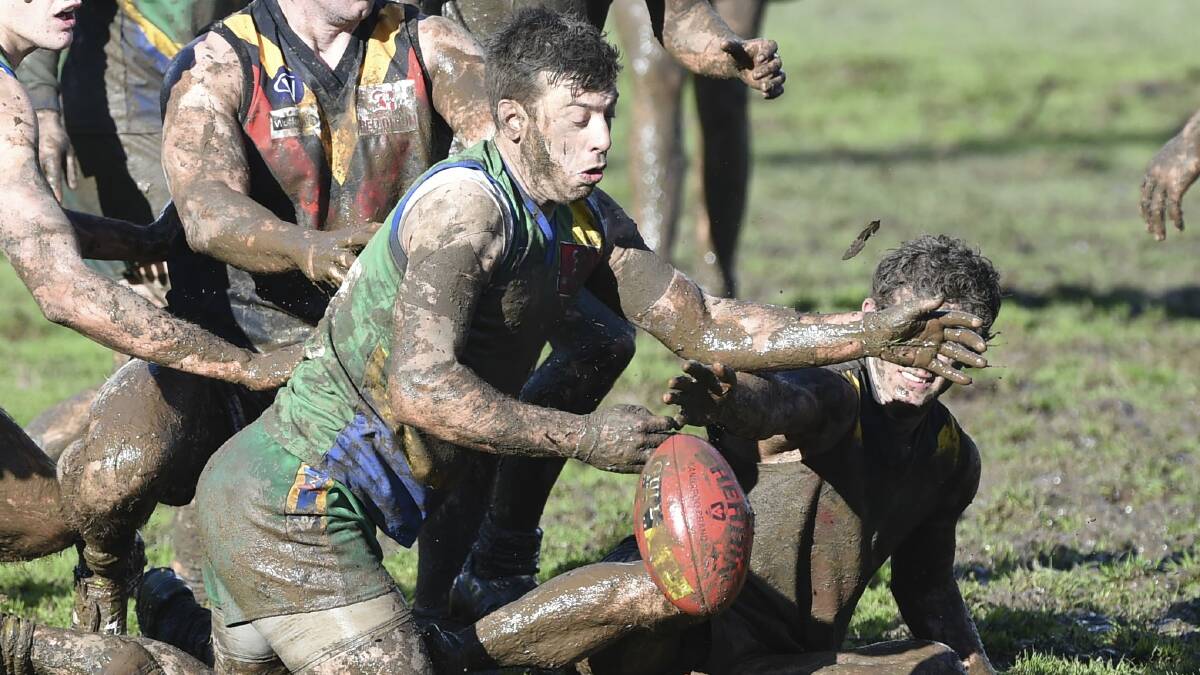 Lake Wendouree's Sam Clifton fights his way through the mud in pursuit of the ball.