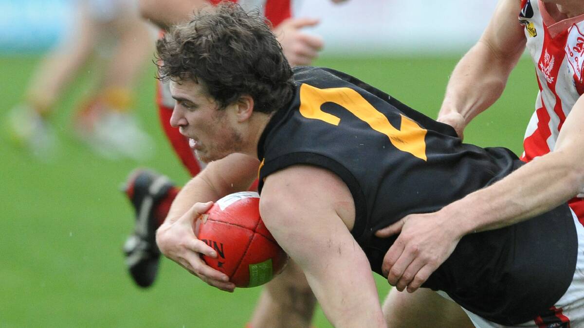Bacchus Marsh coach Cam Richardson fights for the ball. Picture - Lachlan Bence.
