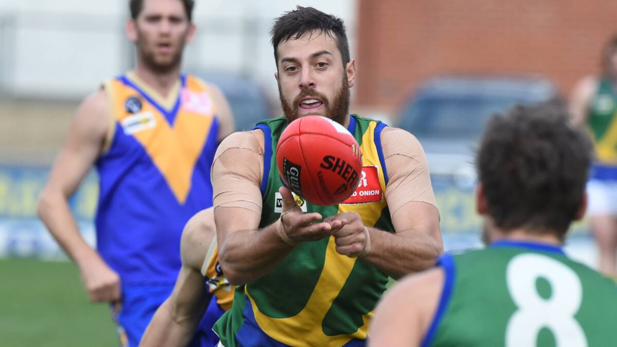 Sam Clifton dishes off a handball for Lake Wendouree.
