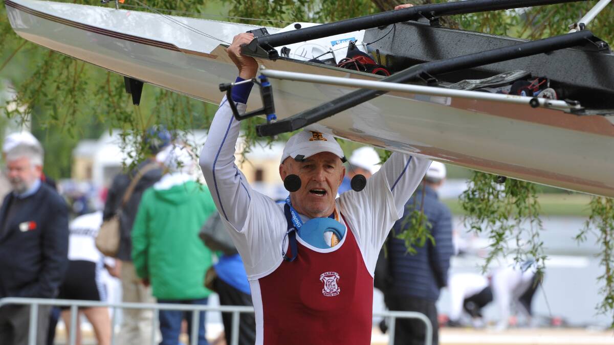 VICTORY WALK: Kim Mackney carries his boat back to its trailer after his victory.