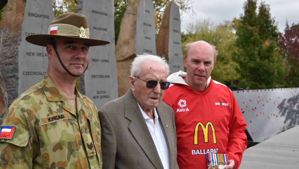 Sergeant Allan Kincaid of the 8th/7th Battalion, Royal Victoria Regiment, World War II veteran George Remmington and Ballarat Red Devils chairman Duncan Smith at the Australian Ex-Prisoners of War Memorial.