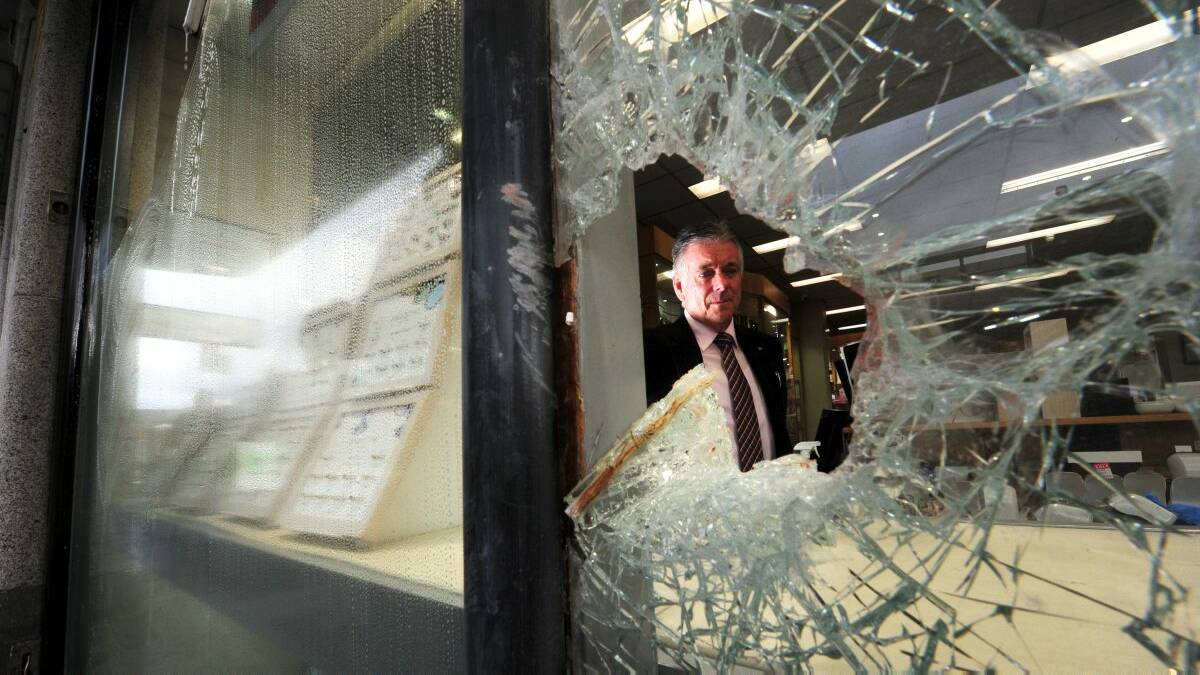 Allan Bros store owner Bill Allan surveys the damage from Peter Aitken's break-in, where he cut his hand on the glass on August 19, 2013. Picture: Jeremy Bannister