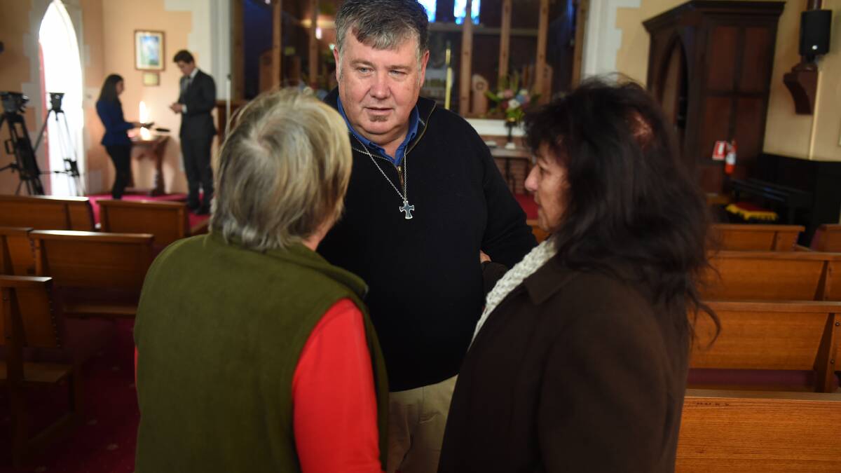 Fr. Jeff O'Hare speaks with parishoners about the theft on Thursday morning. PICTURE: LACHLANE BENCE
