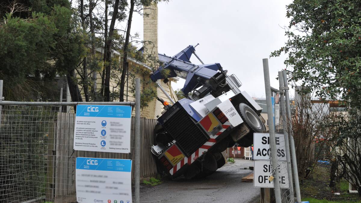 This crane toppled into a house owned by Ballarat Clarendon College on Tuesday morning. PICTURE: JEREMY BANNISTER