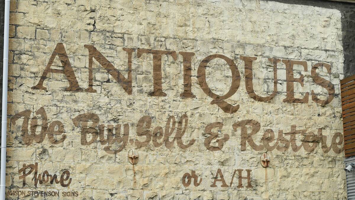 The old antiques sign on the Bluestone Bar on the corner of Mair and Camp streets, Ballarat. PICTURE: JUSTIN WHITELOCK