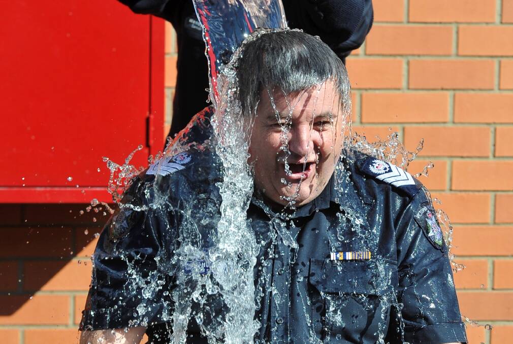  Senior Sergeant Peter McCormick taking part in the Ice Bucket Challenge. PICTURE: LACHLAN BENCE
