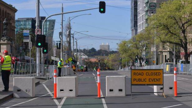 Anti-terror bollards have been set up along the grand final parade route on Spring Street. Photo: Eddie Jim
