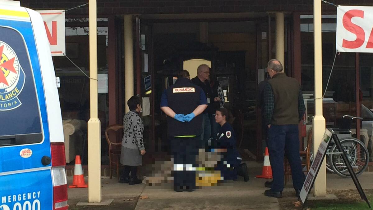 Ambulance Victoria staff treat the woman. PICTURE: PATRICK BYRNE 