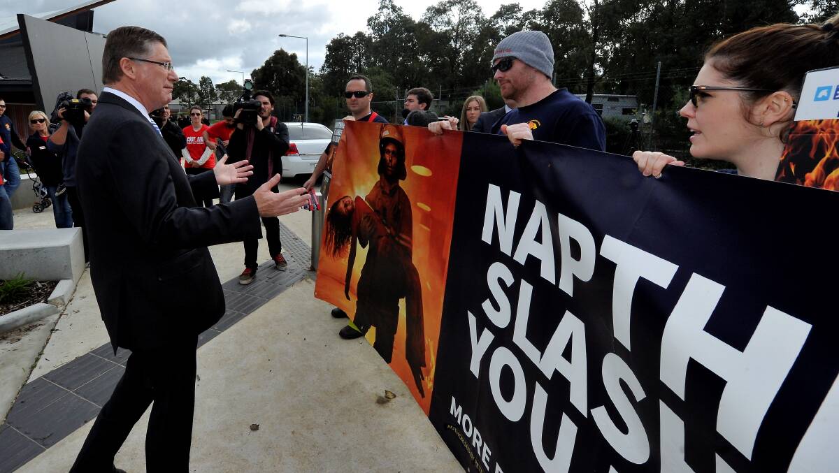  Premier Denis Napthine is confronted by angry emergency services workers. PICTURES: JEREMY BANNISTER