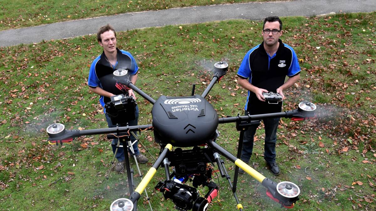 Unmanned Aerial Vehicles director Mathew Herbert and maintenance controller Leon Dwyer with one of their multi-rotor drones. 
PICTURE: JEREMY BANNISTER