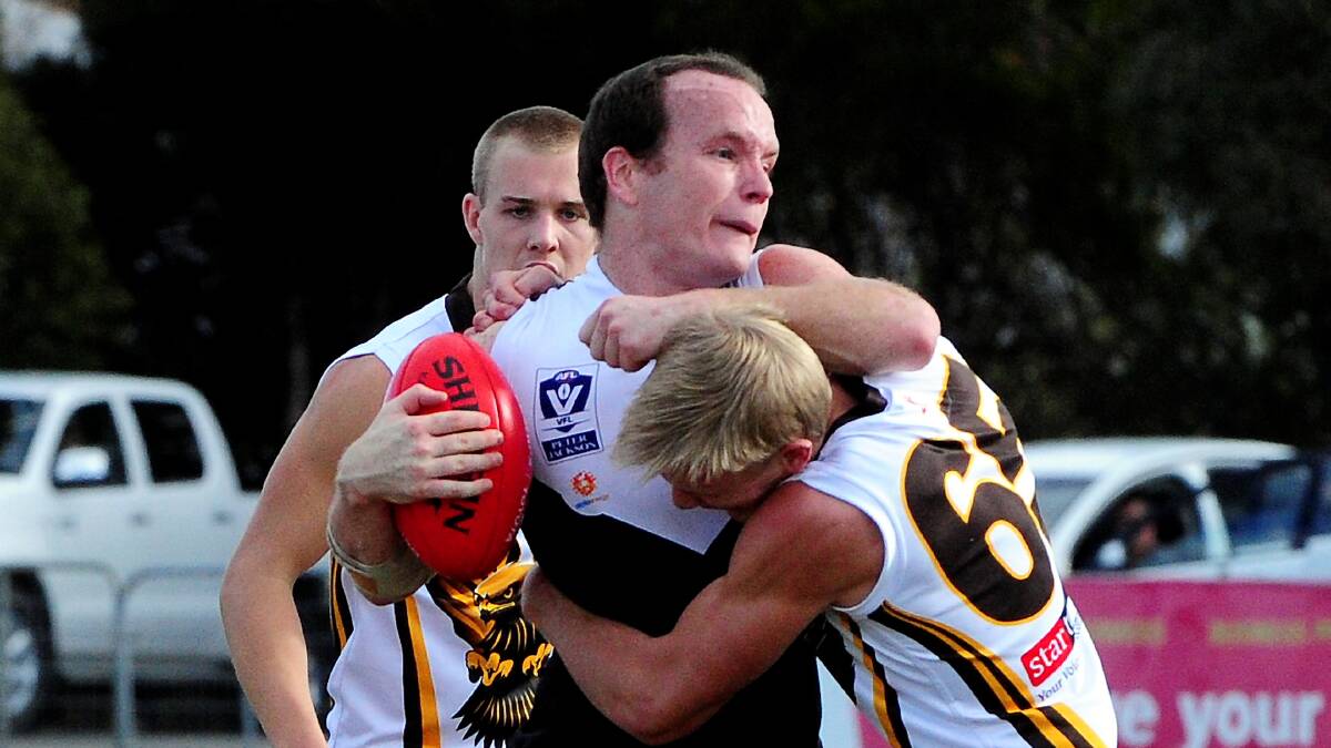 Box Hill Hawk Will Langford tackles North Ballarat Rooster Steve Clifton in a VFL match at Eureka Stadium.
picture: JEREMY BANNISTER