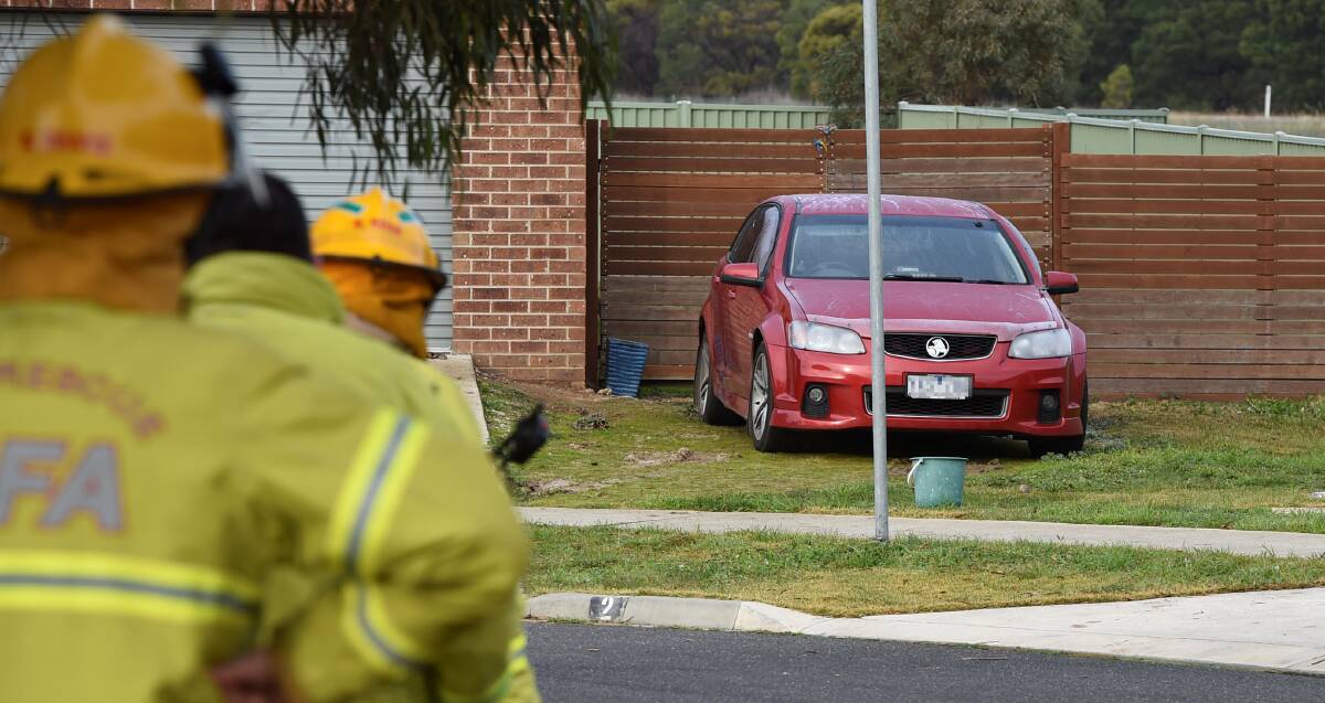 Firefighters and police at the scene of the car bombing in Delaney Drive, Miners Rest, on Saturday. PICTURE: LACHLAN BENCE