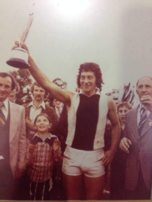 Kevin “Digger” Rinaldi holds the premiership cup aloft while playing for Dunnstown.