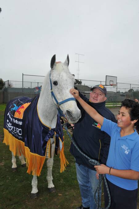  Our Lady Help of Christians Primary School pupil Jack Sampi and Subzero owner Graham Salisbury pat the 1992 Melbourne Cup winner. Subzero was inducted into the Australian Racing Hall of Fame in Canberra last month. PICTURE: LACHLAN BENCE