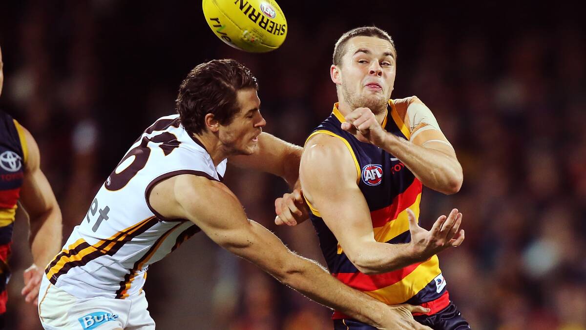  Adelaide’s Brad Crouch is tackled by another Ballarat export, Hawthorn’s Isaac Smith, on Friday night.
PICTURE: GETTY IMAGES