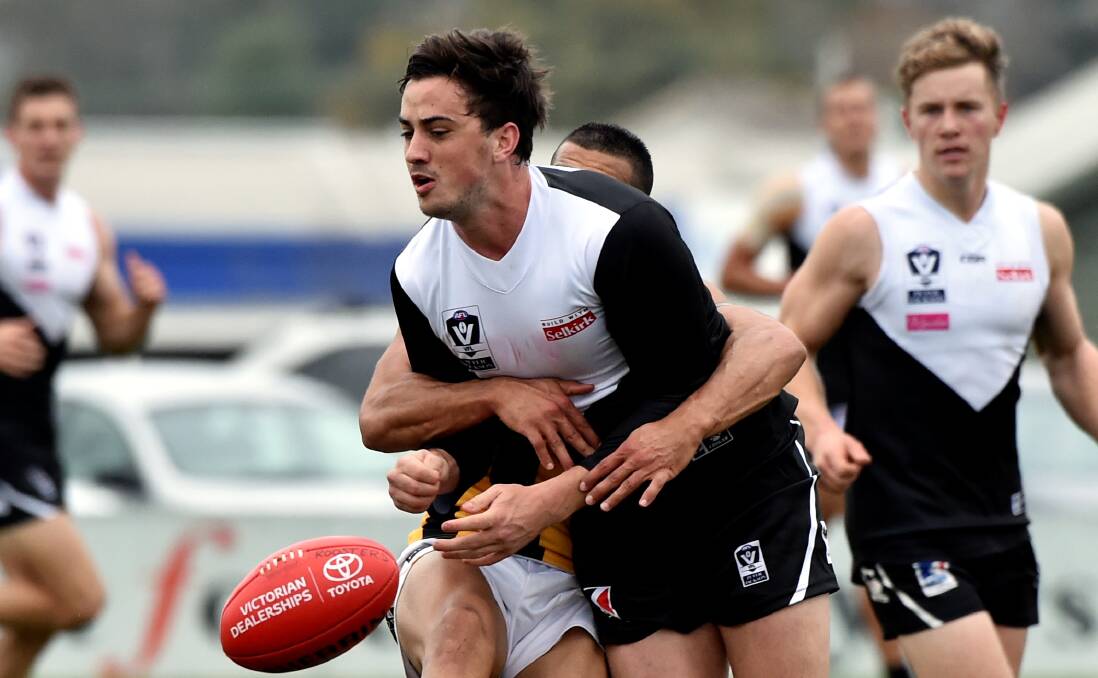 CRUNCH: Rooster Taylor Garner feels the squeeze as North Ballarat is pushed out of match-winning contention at Eureka Stadium. Photo: Jeremy Bannister