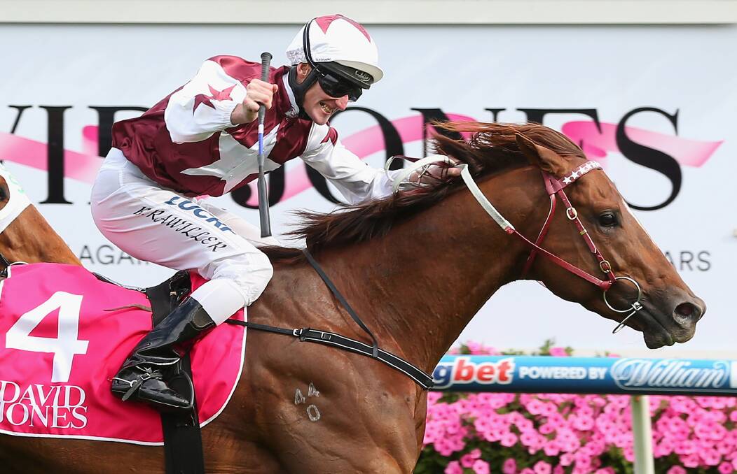 Brad Rawiller punches the air aboard Trust In A Gust in Saturday's Toorak Handicap. Picture - Getty Images.