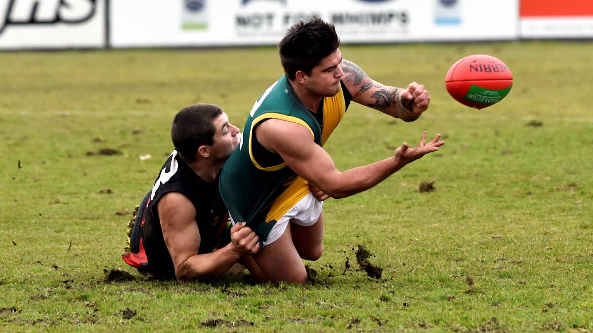 Buninyong's Sam Turner tackles Gordon's Steve Patterson on Saturday. Picture - Jeremy Bannister.