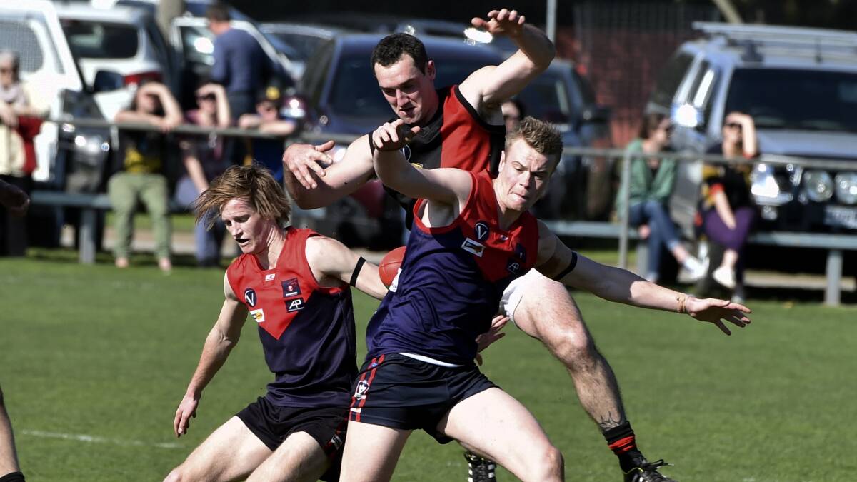 Nicholas Weightman (Bungaree), Adam Scott (Buninyong) and Tom Wilson (Bungaree) contest for the ball on Saturday. Picture - Jeremy Bannister.   