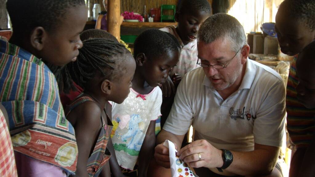 The late Alan Parker with children in Malawi. 