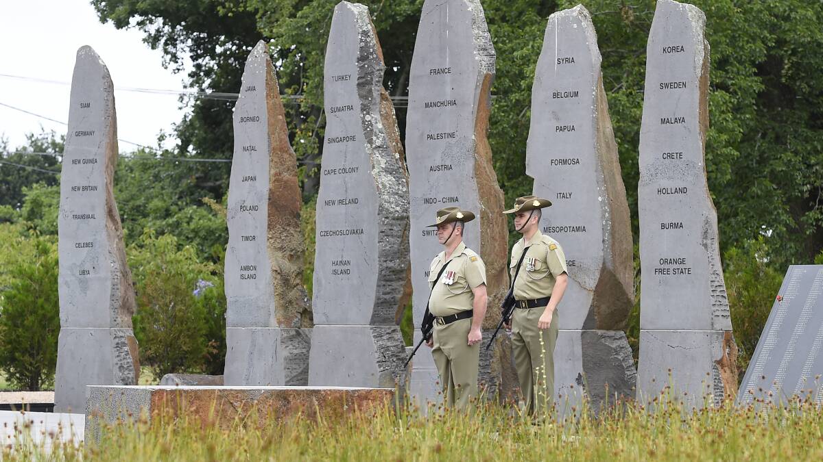 Soldiers stand to attention at the Prisoners of War memorial. PICTURE: JUSTIN WHITELOCK