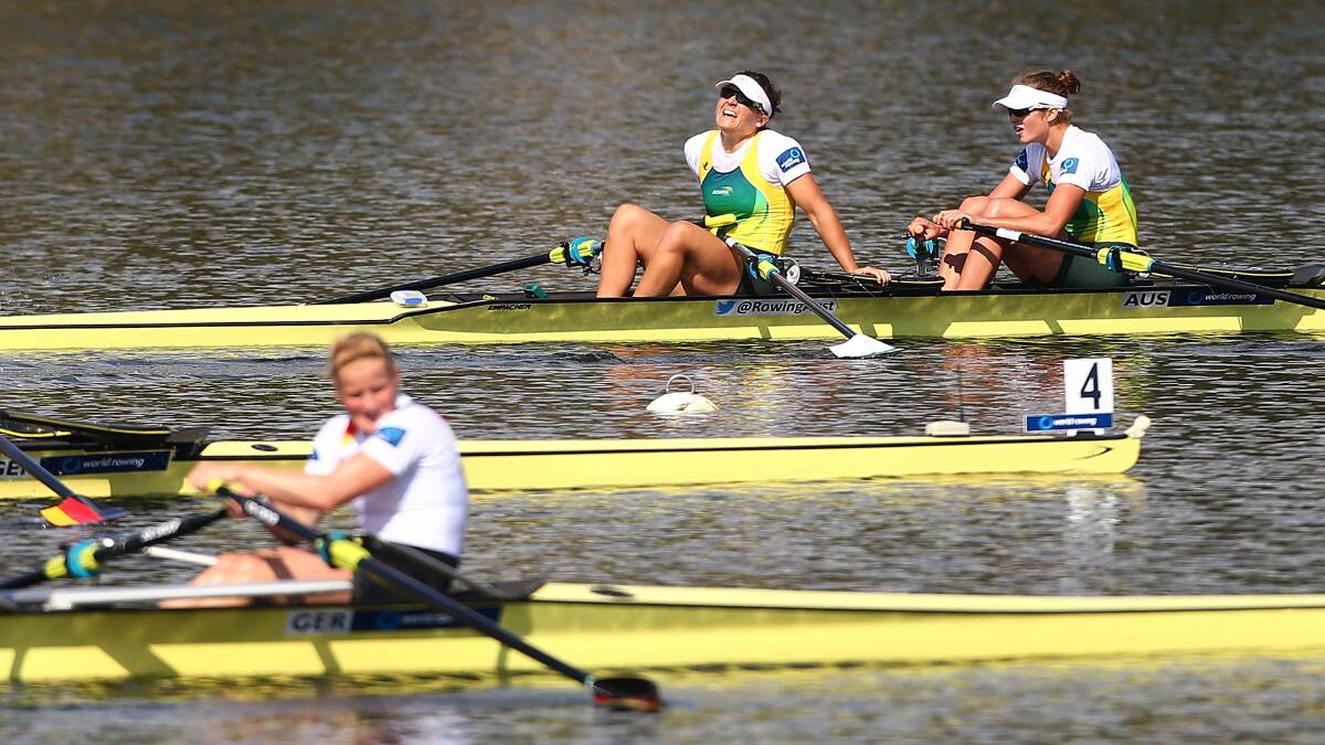 Sally Kehoe and Olympia Aldersey of Australia look exhausted after winning the Womens Double Sculls race during the Rowing World Cup. Photo: Getty
