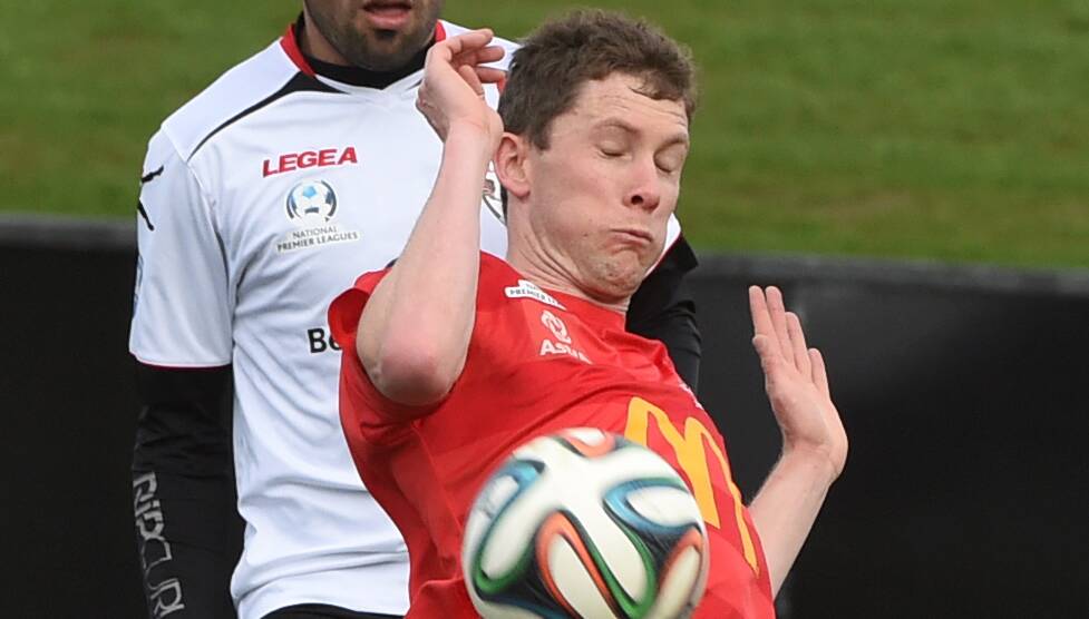 Simon Murphy (Red Devils) attempts to control the ball.