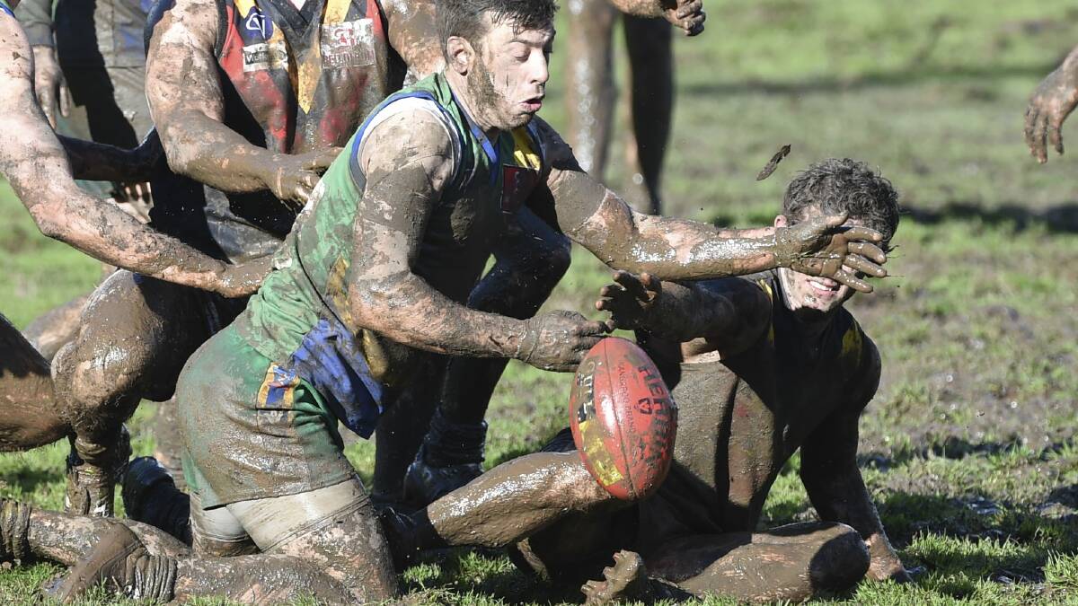 Sam Clifton, of Lake Wendouree, finds himself caked in mud. 