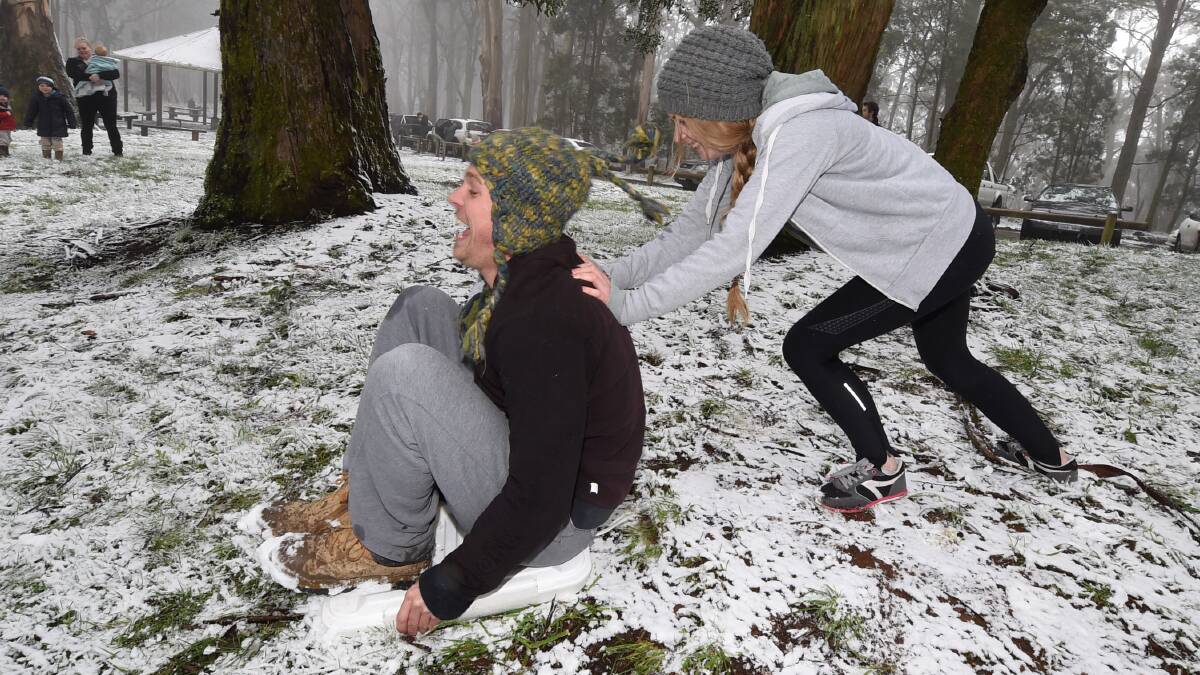 Josh Corcran and Jayne Banks have fun in the snow at Mt Buninyong. 